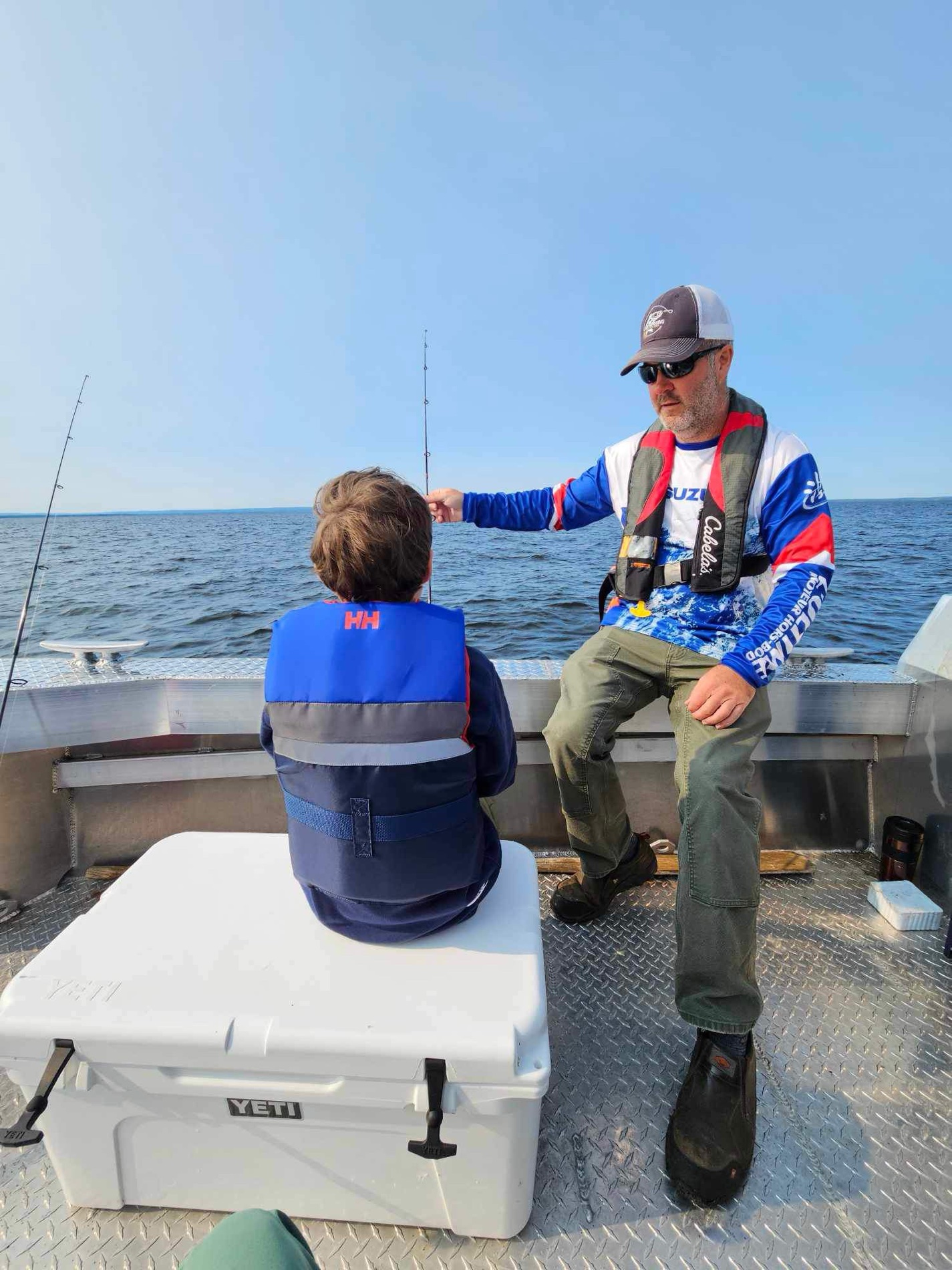 Young angler holding two walleye caught on a guided fishing charter on Lake Nipissing