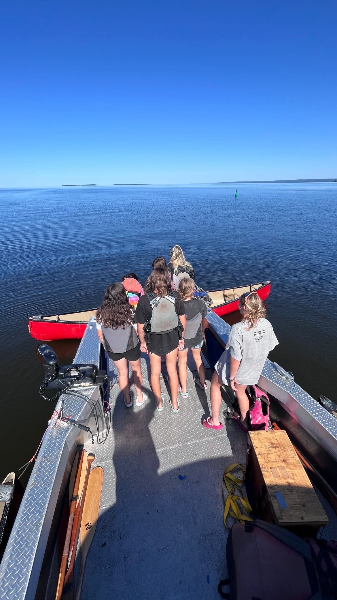 Kids stepping off a boat at a remote, boat-access-only campsite on Lake Nipissing